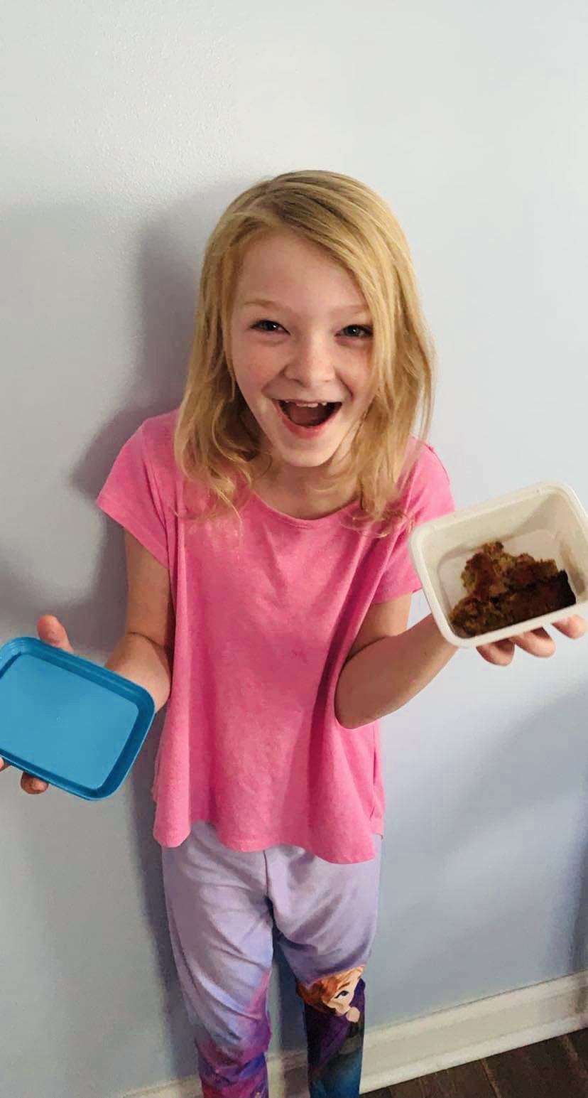 Child holding an empty food container